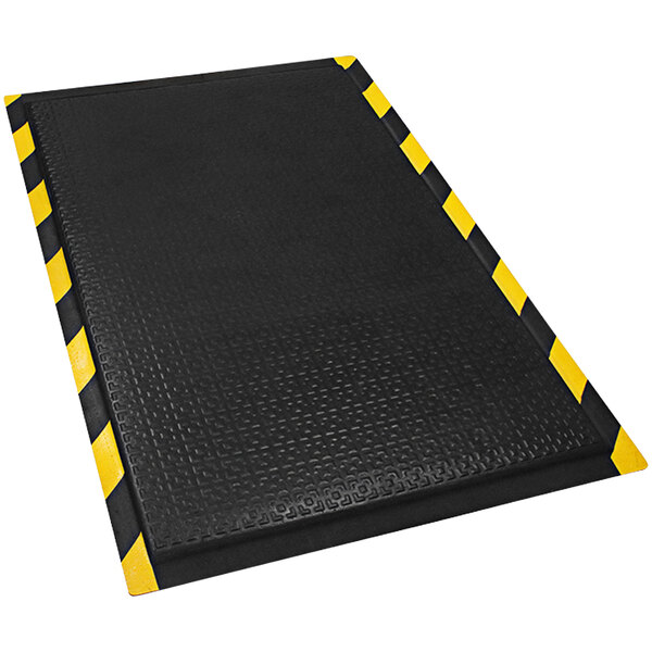 A black anti-fatigue mat with a yellow striped border.