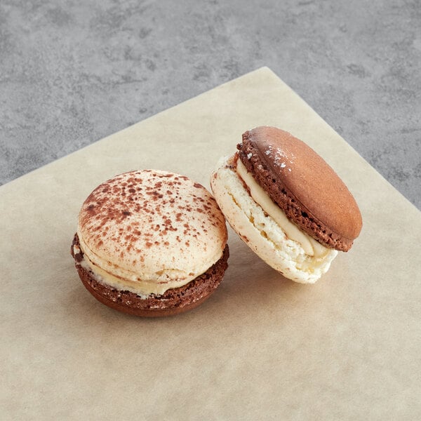 Two Horchata Macarons on a piece of paper.