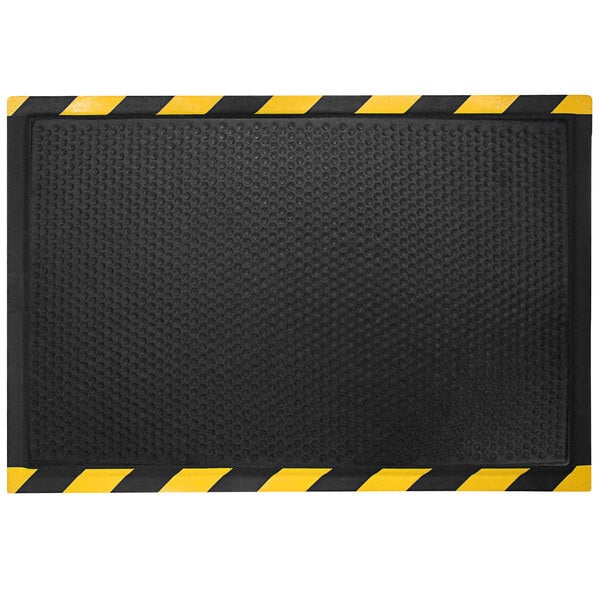 A black mat with a yellow striped border.