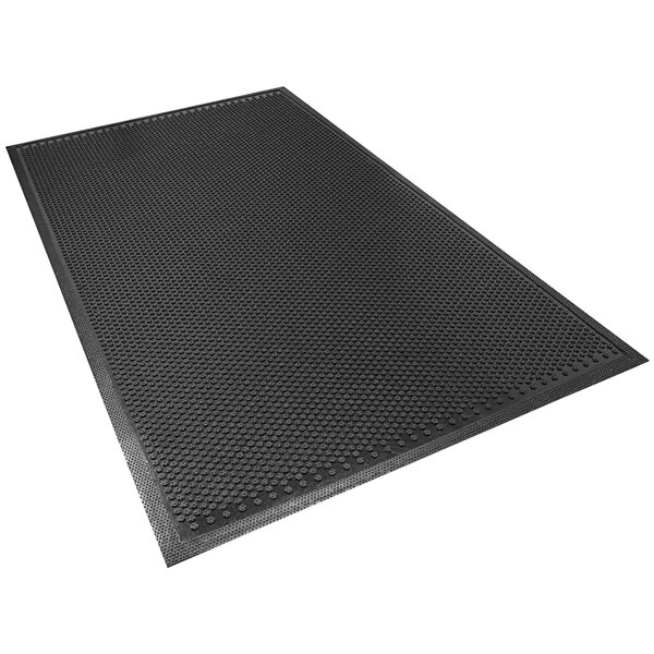 A black Safety Scrape mat with holes on a white background.