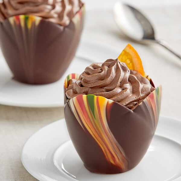 A Mona Lisa medium chocolate tulip cup with a marbled design filled with chocolate and a swirl of frosting on top.