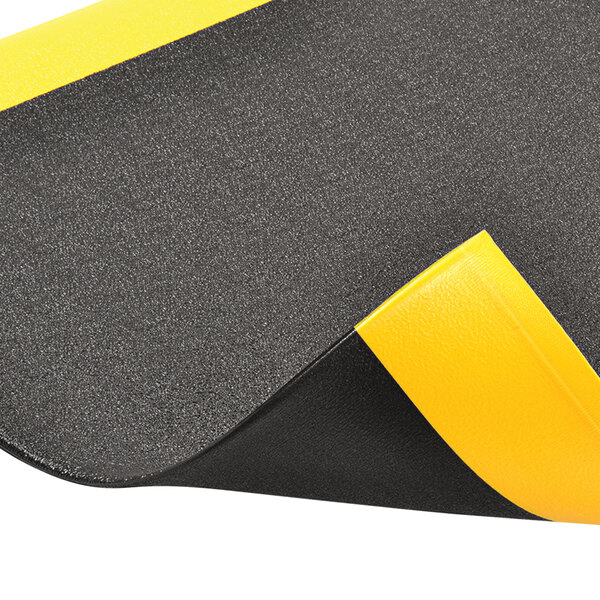 Notrax Pebble Step SofTred DynaShield 2' x 3' Black / Yellow AntiFatigue Mat 415S0523BY 5/8