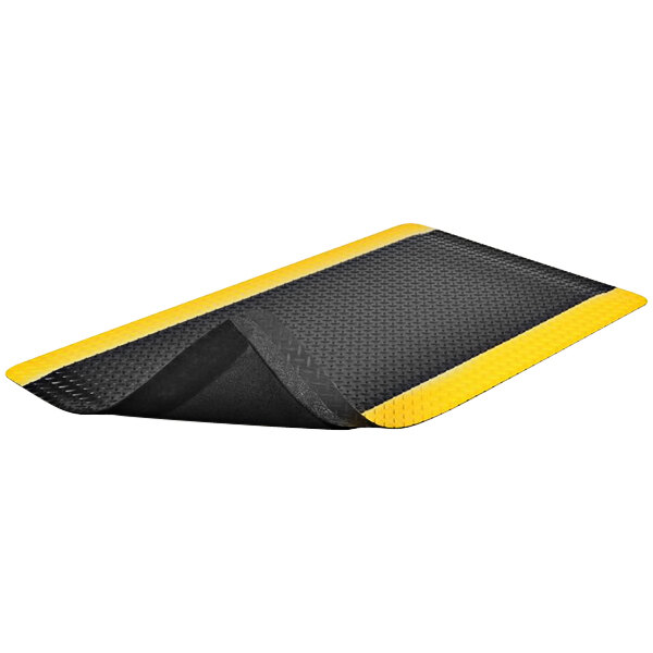 A black and yellow Notrax Ergo Trax Grande anti-fatigue mat with a black border.