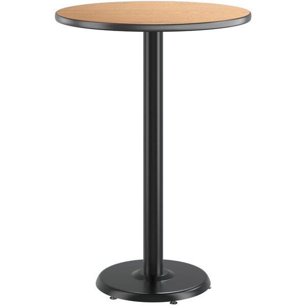 A round Lancaster Table & Seating bar table with a reversible walnut and oak laminated top on a black pole.
