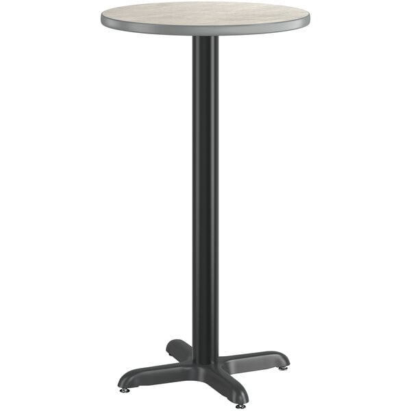 A Lancaster Table & Seating round white and slate gray table top with a black base.