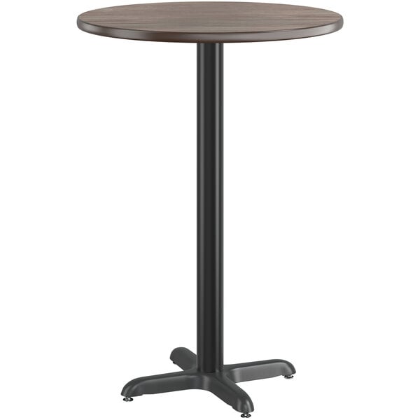 A round Lancaster Table & Seating bar table with a black pole and a reversible white birch and ash laminated top.