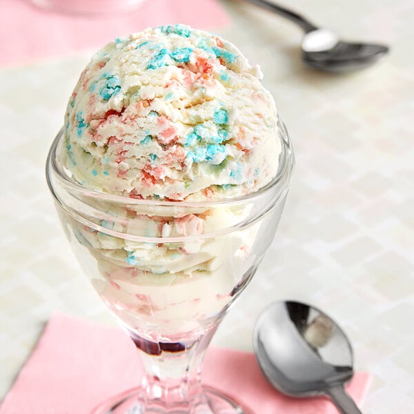 A scoop of ice cream with Fizzy Pink and Blue Cotton Candy Cluster toppings and a spoon.