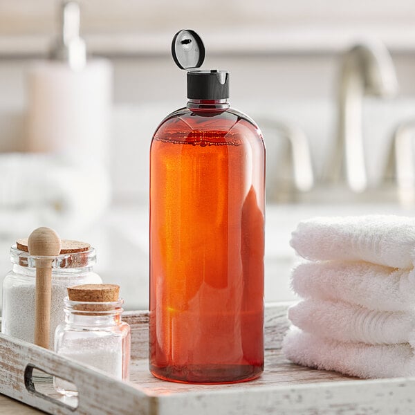 A tray with a Boston Round amber plastic bottle of liquid and towels.