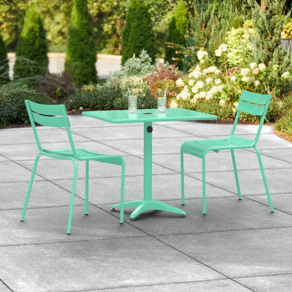 A seafoam green table and chairs on a patio.