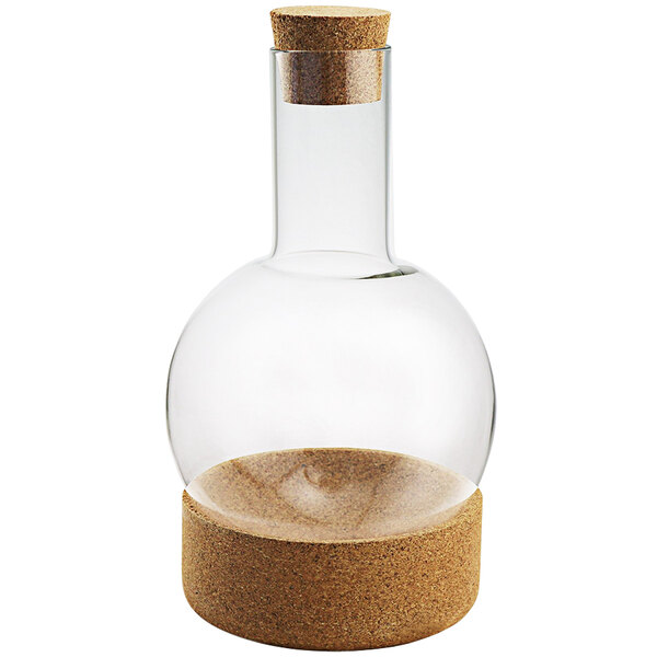 A Franmara glass decanter with cork stopper on a table.