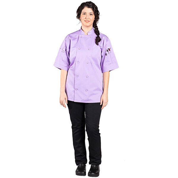 A woman wearing a lilac Uncommon Chef short sleeve chef coat.