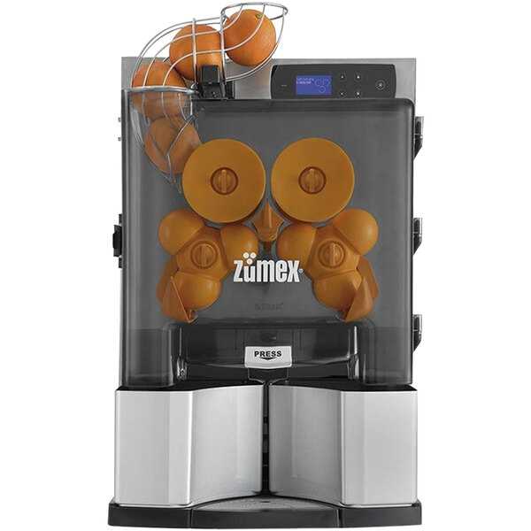 A Zumex Essential Pro juicer with oranges in it.