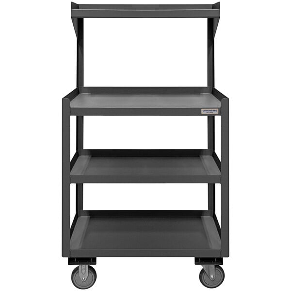 A grey metal mobile shop desk with shelves and wheels.