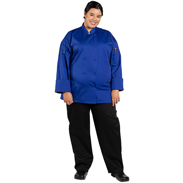 A woman wearing a deep royal blue Uncommon Chef long sleeve chef coat.