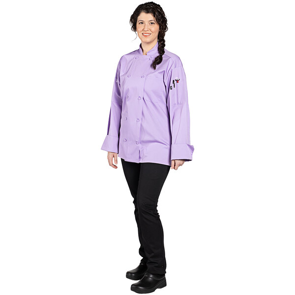 A woman wearing a lilac Uncommon Chef Pulse long sleeve chef coat.