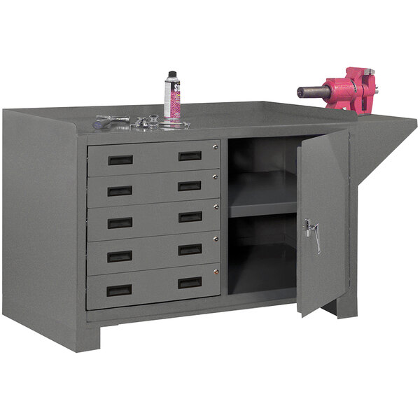 A grey metal workbench with a pink tool in a drawer.