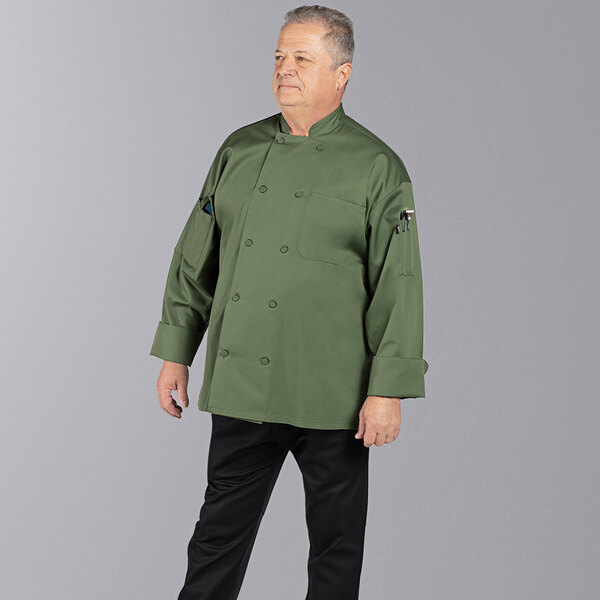 A man wearing a sea green Uncommon Chef long sleeve chef coat.