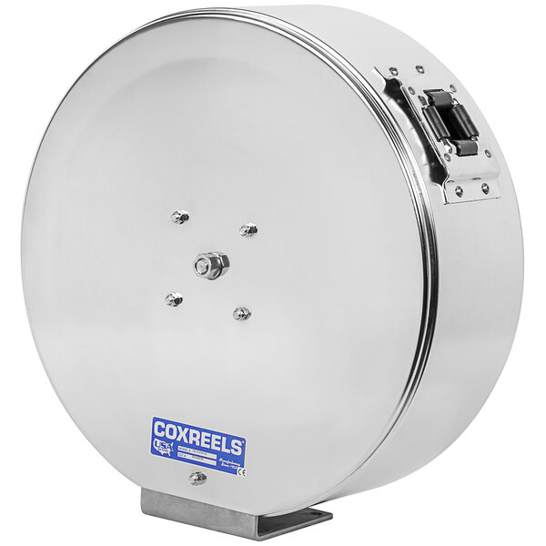 A silver circular stainless steel Coxreels hose reel with black handles.
