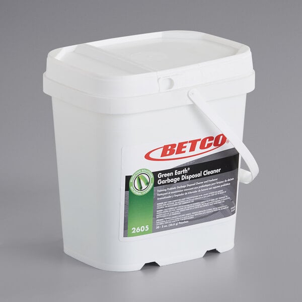 A white Betco bucket of 30 green Earth garbage disposal cleaner portion packs.