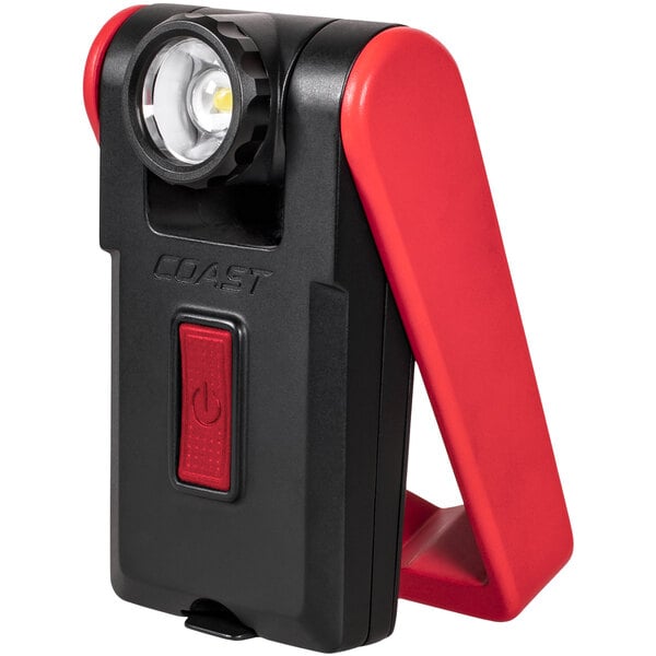 A close-up of a red and black Coast magnetic work light.