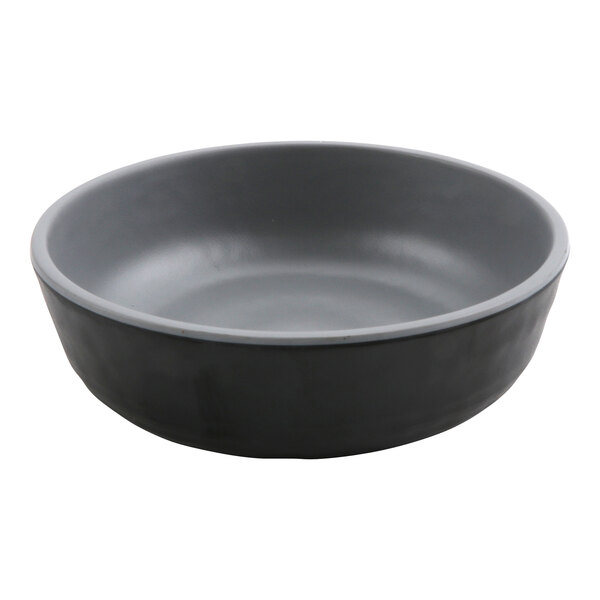 A black shallow dish with a grey rim.