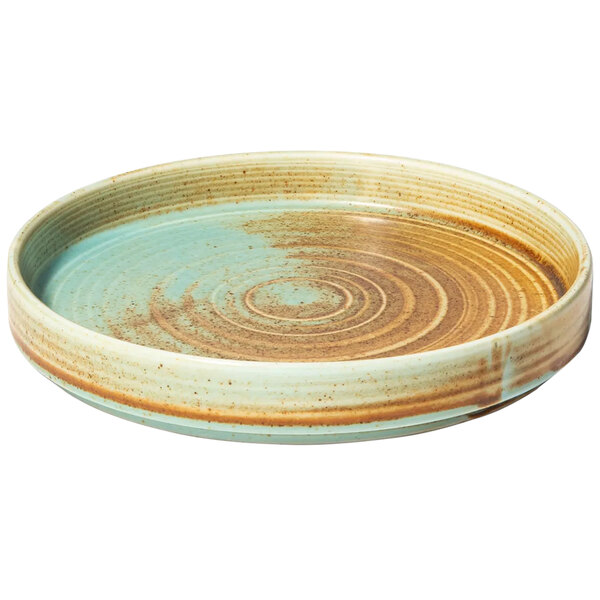 A Bon Chef Tavola teal porcelain bread and butter plate with a circular brown and blue swirl pattern.