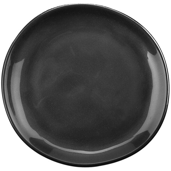A black GET Cosmo melamine plate with an irregular rim.