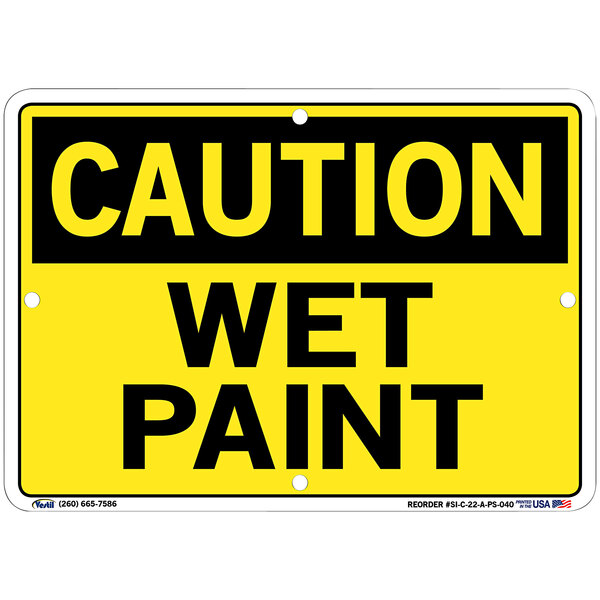 A yellow sign with black text that says "Caution / Wet Paint" on a white background.