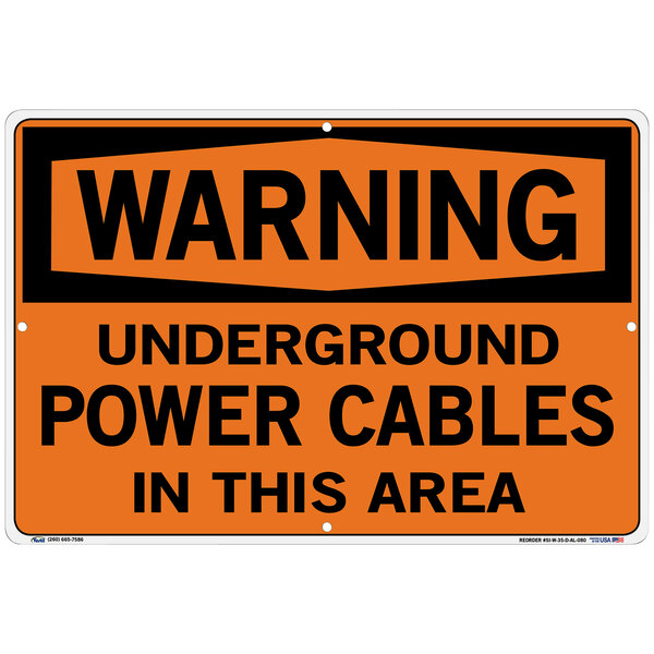 A white and black aluminum Warehouse sign that reads "Warning Underground Power Cables In This Area"