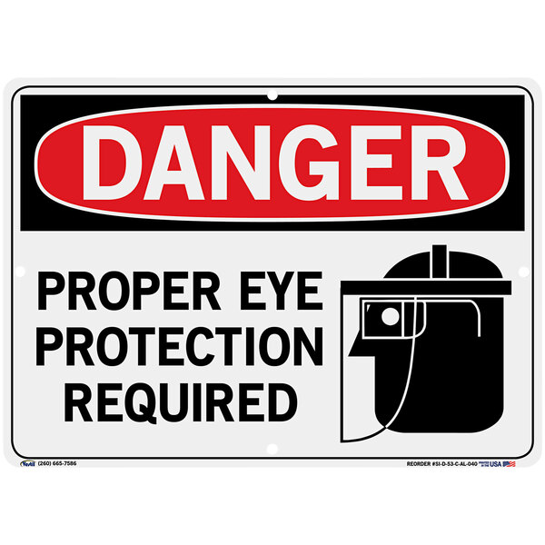 An aluminum warehouse sign with black and white text that says "Danger / Proper Eye Protection Required"
