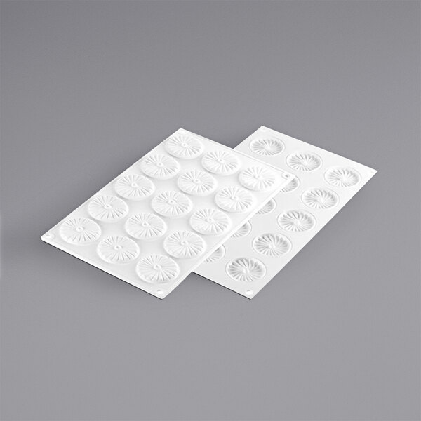 A white Silikomart silicone chocolate mold with circles and pleats.