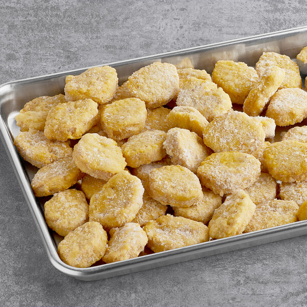 A tray of Tindle plant-based vegan chicken nuggets on a metal surface.