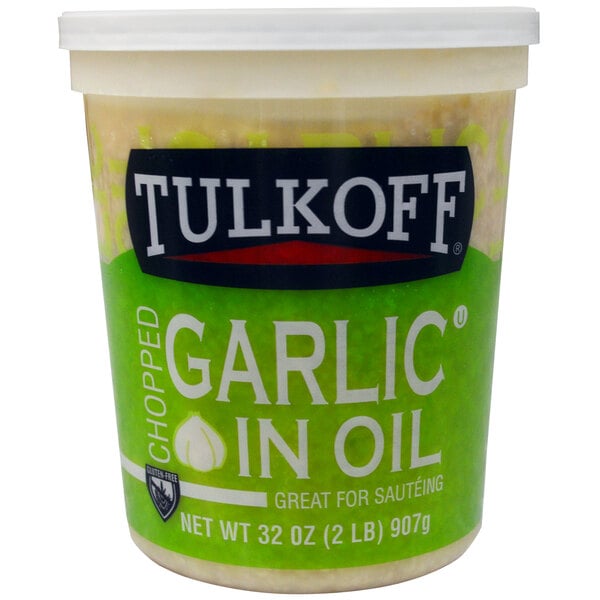 A case of Tulkoff chopped garlic in oil on a deli counter.