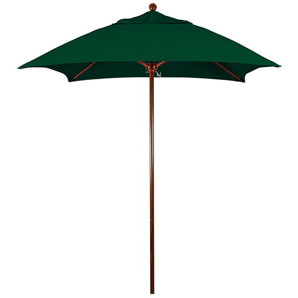 A green California Umbrella with a wooden pole.