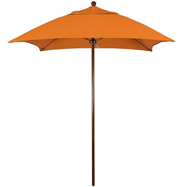 A California Umbrella orange table umbrella with a wooden pole and Tuscan Sunbrella fabric.