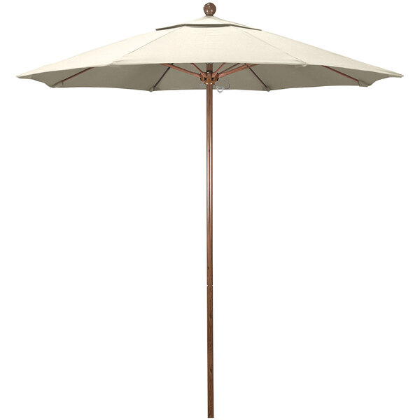 A California Umbrella with an antique beige fabric canopy and a wooden pole.