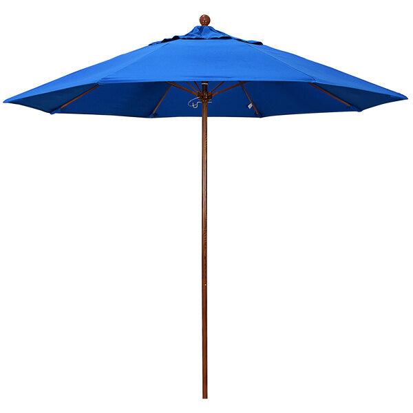 A California Umbrella royal blue umbrella with a wooden pole.