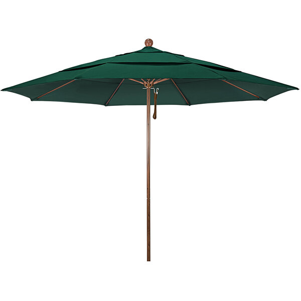 A close-up of a California Umbrella with a green Sunbrella canopy and a wooden pole.
