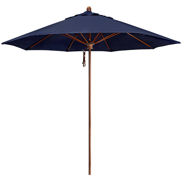 A California Umbrella Lodge Series 9' outdoor umbrella with a navy Sunbrella canopy and a simulated wood aluminum pole.