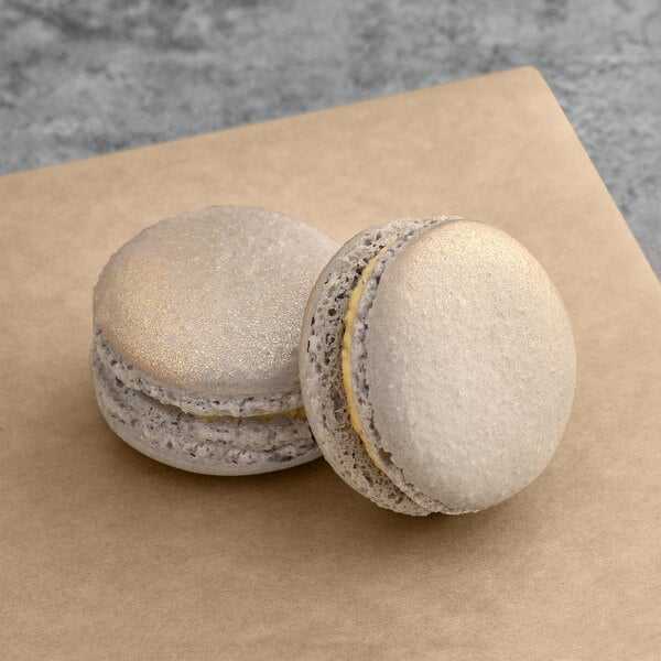 Two Venus Macarons on a brown paper.