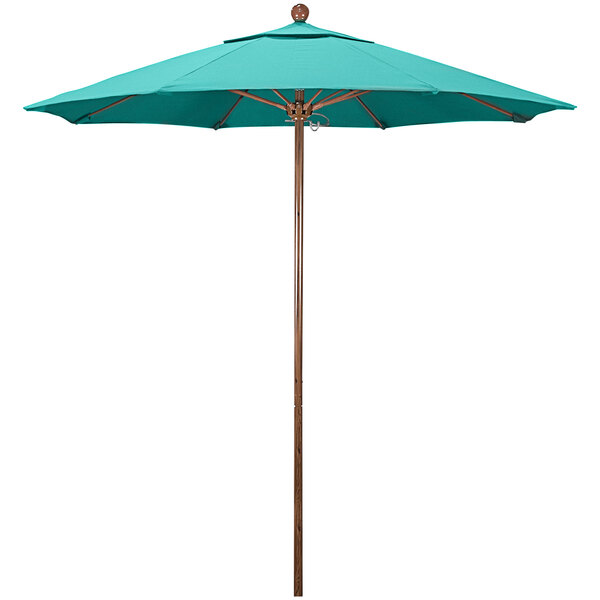 A close-up of a blue California Umbrella with a wooden pole.