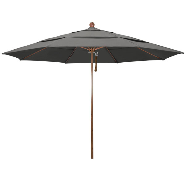 A close-up of a black California Umbrella with a wooden pole.