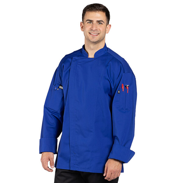 A man wearing a Uncommon Chef deep royal blue chef coat with a mesh back.