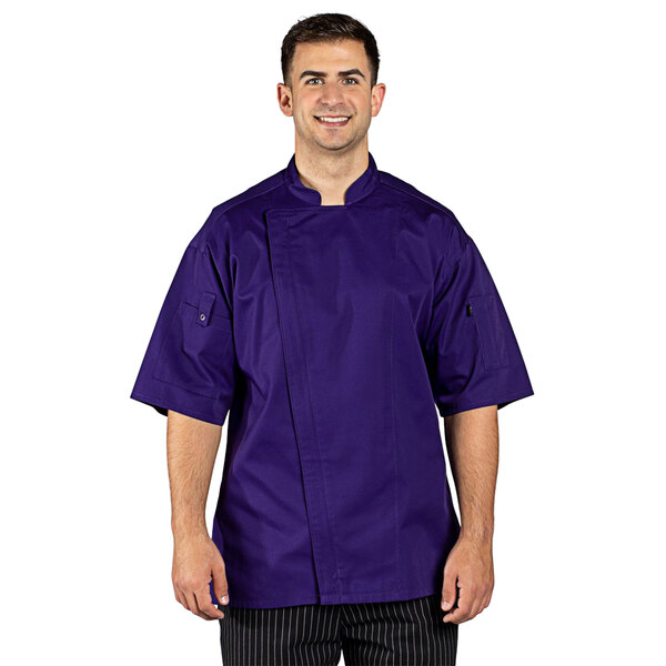 A man wearing a grape Uncommon Chef short sleeve chef coat.