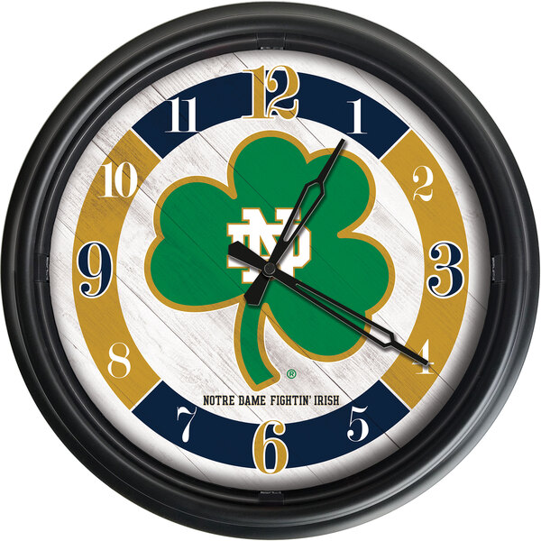 A Holland Bar Stool Notre Dame wall clock with a shamrock logo on it.