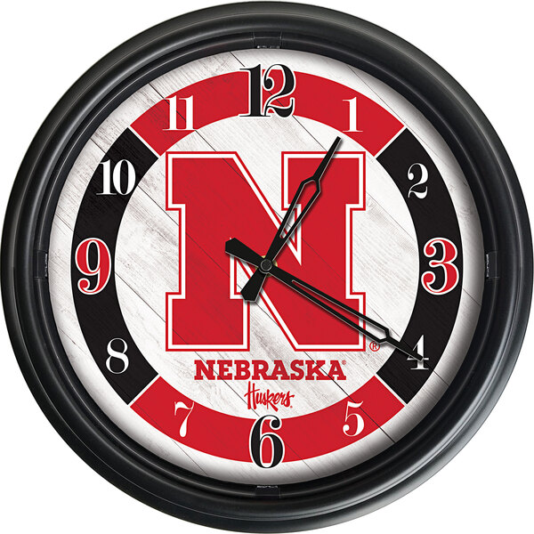A white Holland Bar Stool clock with a red and black University of Nebraska logo.