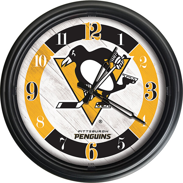 A Holland Bar Stool Pittsburgh Penguins wall clock with the team logo and LED lights.