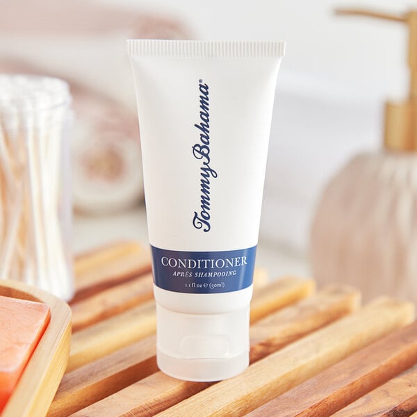 A white tube of Tommy Bahama conditioner with a blue label.
