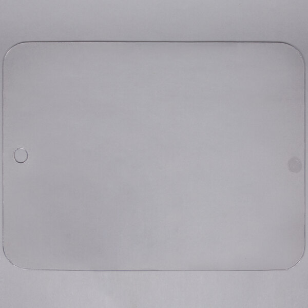 A clear rectangular cover with a hole in the middle.