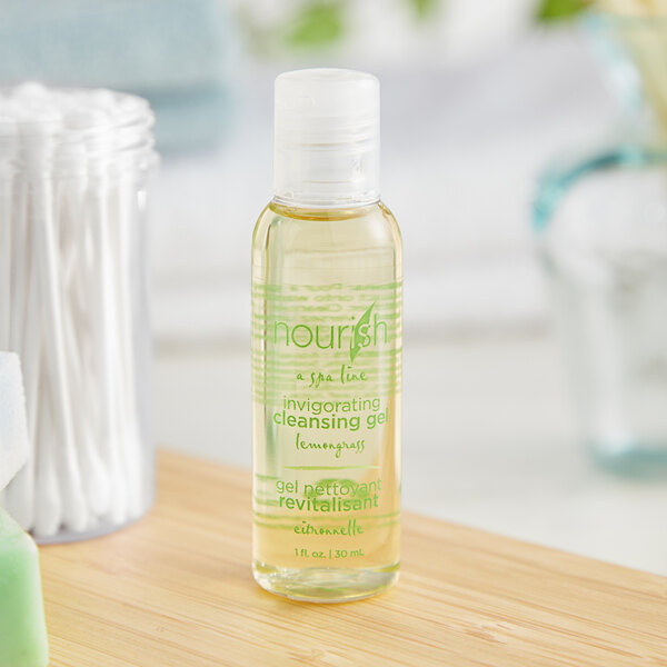 A case of small Nourish lemongrass body wash bottles on a counter.